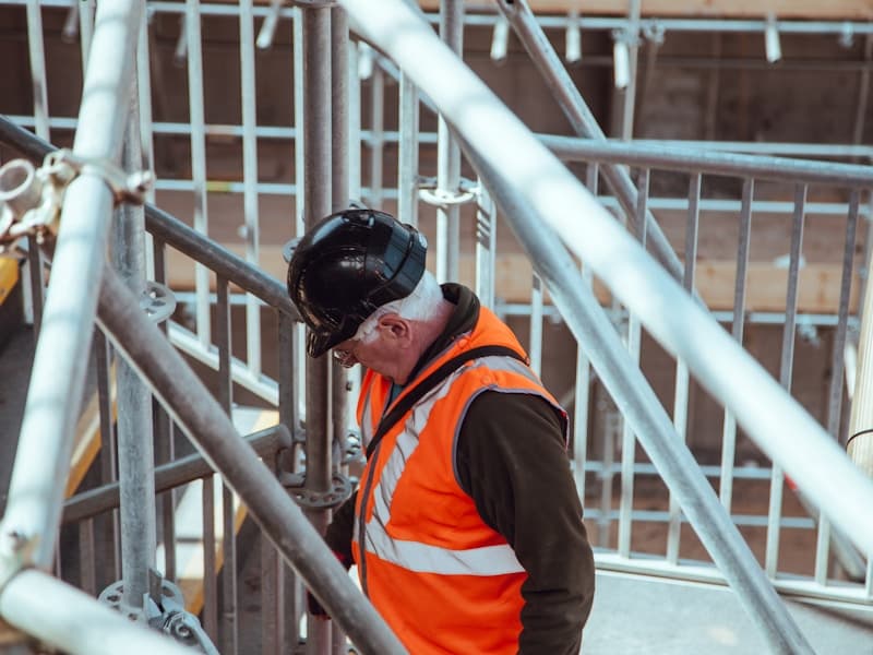 Structural engineer inspecting a building structure from scaffolding during construction